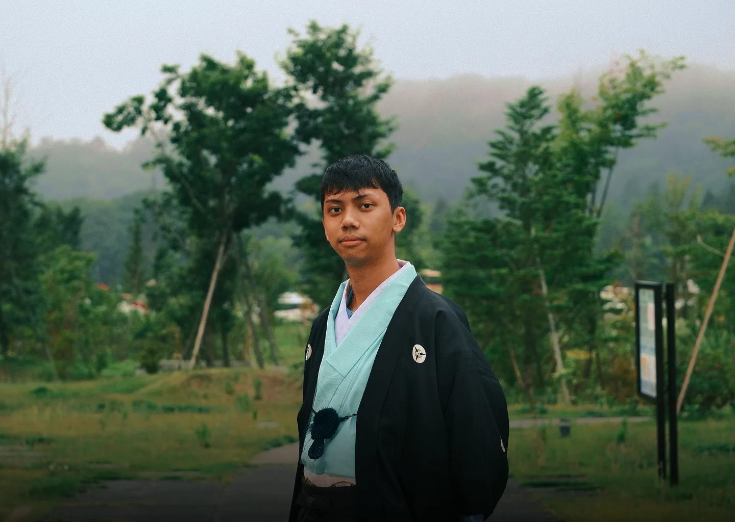Nhat Linh standing on a path through a bamboo grove